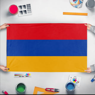 A mockup of the custom flag 'Flag of Armenia flag' held up on a table during print checking