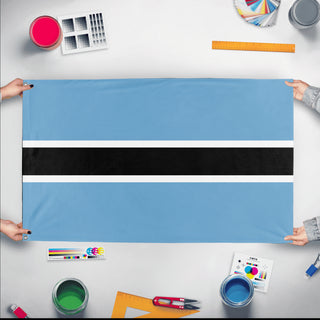 A mockup of the custom flag 'Flag of Botswana flag' held up on a table during print checking