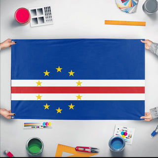 A mockup of the custom flag 'Flag of Cabo Verde flag' held up on a table during print checking