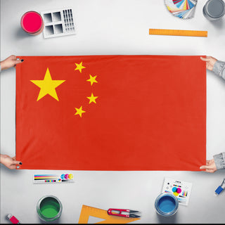 A mockup of the custom flag 'Flag of China flag' held up on a table during print checking