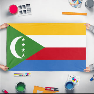 A mockup of the custom flag 'Flag of Comoros flag' held up on a table during print checking