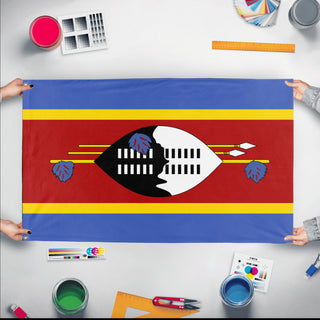 A mockup of the custom flag 'Flag of Eswatini flag' held up on a table during print checking