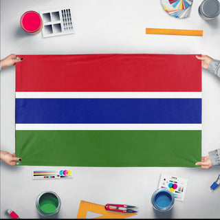 A mockup of the custom flag 'Flag of Gambia flag' held up on a table during print checking