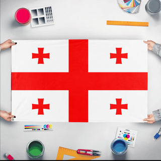 A mockup of the custom flag 'Flag of Georgia flag' held up on a table during print checking