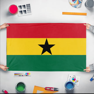 A mockup of the custom flag 'Flag of Ghana flag' held up on a table during print checking