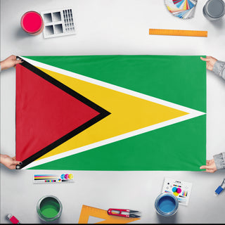 A mockup of the custom flag 'Flag of Guyana flag' held up on a table during print checking