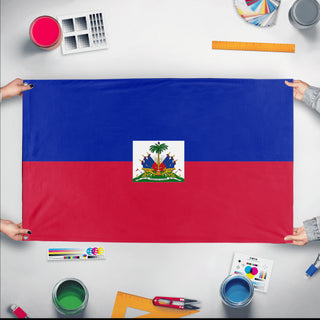 A mockup of the custom flag 'Flag of Haiti flag' held up on a table during print checking