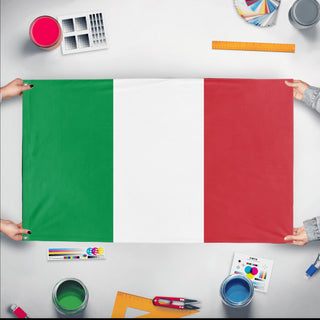 A mockup of the custom flag 'Flag of Italy flag' held up on a table during print checking