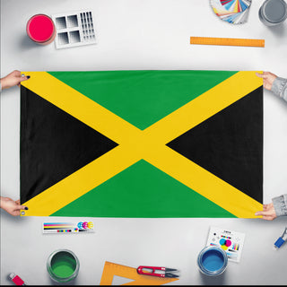 A mockup of the custom flag 'Flag of Jamaica flag' held up on a table during print checking