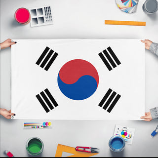 A mockup of the custom flag 'Flag of Korea' held up on a table during print checking