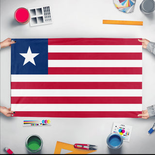 A mockup of the custom flag 'Flag of Liberia flag' held up on a table during print checking