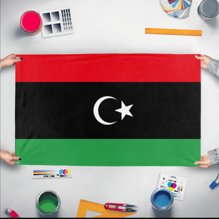 A mockup of the custom flag 'Flag of Libya flag' held up on a table during print checking