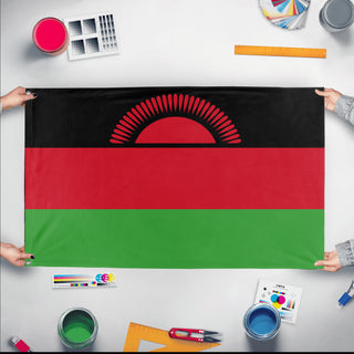 A mockup of the custom flag 'Flag of Malawi flag' held up on a table during print checking
