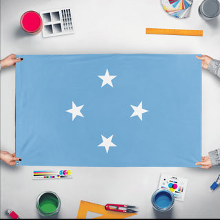 A mockup of the custom flag 'Flag of Micronesia flag' held up on a table during print checking