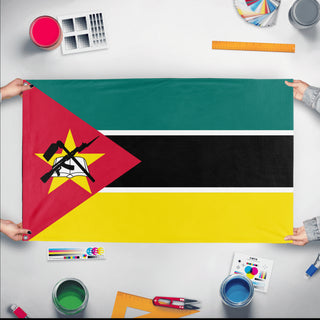 A mockup of the custom flag 'Flag of Mozambique flag' held up on a table during print checking
