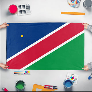 A mockup of the custom flag 'Flag of Namibia flag' held up on a table during print checking