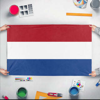 A mockup of the custom flag 'Flag of Netherlands flag' held up on a table during print checking
