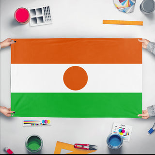 A mockup of the custom flag 'Flag of Niger flag' held up on a table during print checking