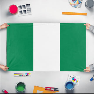 A mockup of the custom flag 'Flag of Nigeria flag' held up on a table during print checking