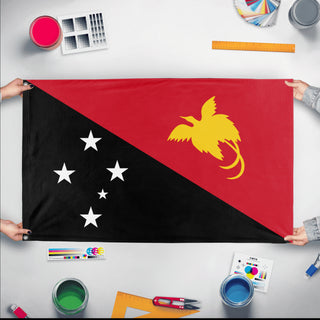A mockup of the custom flag 'Flag of Papua New Guinea flag' held up on a table during print checking
