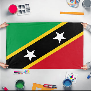 A mockup of the custom flag 'Flag of Saint Kitts and Nevis flag' held up on a table during print checking