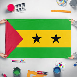 A mockup of the custom flag 'Flag of Sao Tome and Principe flag' held up on a table during print checking