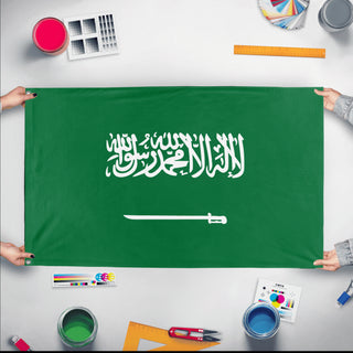 A mockup of the custom flag 'Flag of Saudi Arabia flag' held up on a table during print checking