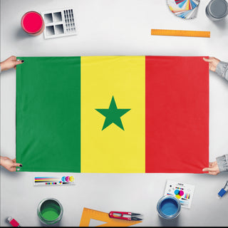 A mockup of the custom flag 'Flag of Senegal flag' held up on a table during print checking