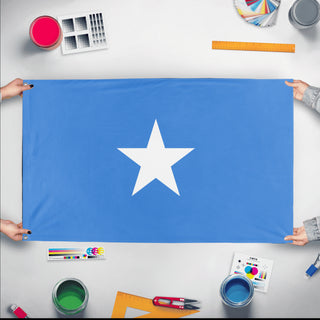 A mockup of the custom flag 'Flag of Somalia flag' held up on a table during print checking