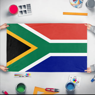 A mockup of the custom flag 'Flag of South Africa flag' held up on a table during print checking