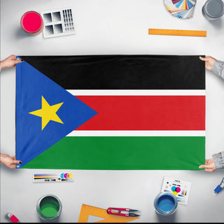 A mockup of the custom flag 'Flag of South Sudan flag' held up on a table during print checking