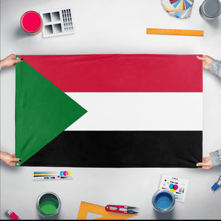 A mockup of the custom flag 'Flag of Sudan flag' held up on a table during print checking