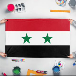 A mockup of the custom flag 'Flag of Syria flag' held up on a table during print checking