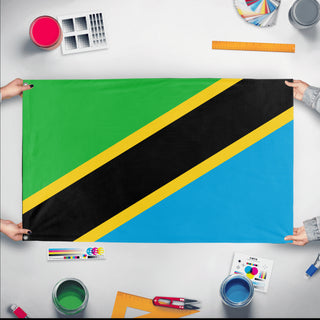 A mockup of the custom flag 'Flag of Tanzania flag' held up on a table during print checking