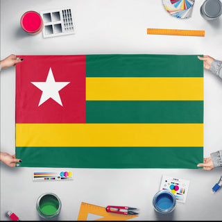 A mockup of the custom flag 'Flag of Togo flag' held up on a table during print checking