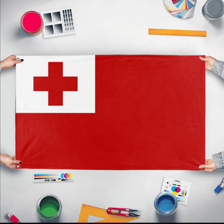 A mockup of the custom flag 'Flag of Tonga flag' held up on a table during print checking