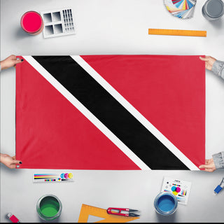 A mockup of the custom flag 'Flag of Trinidad and Tobago flag' held up on a table during print checking