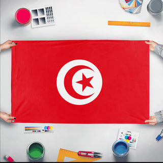 A mockup of the custom flag 'Flag of Tunisia flag' held up on a table during print checking