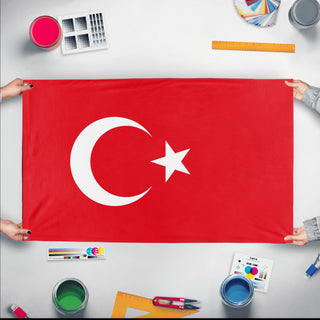A mockup of the custom flag 'Flag of Turkey flag' held up on a table during print checking