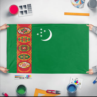 A mockup of the custom flag 'Flag of Turkmenistan flag' held up on a table during print checking