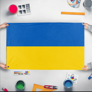 A mockup of the custom flag 'Flag of Ukraine flag' held up on a table during print checking