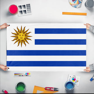 A mockup of the custom flag 'Flag of Uruguay flag' held up on a table during print checking