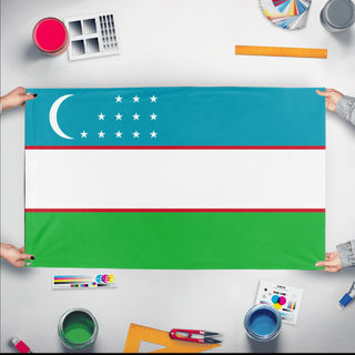 A mockup of the custom flag 'Flag of Uzbekistan flag' held up on a table during print checking