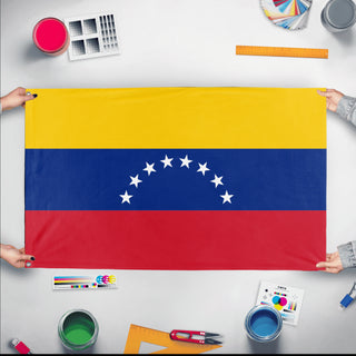 A mockup of the custom flag 'Flag of Venezuela flag' held up on a table during print checking