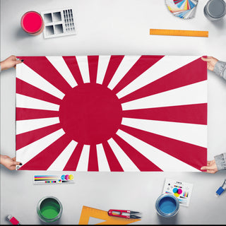 A mockup of the custom flag 'Japanese Empire Flag' held up on a table during print checking