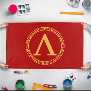 A mockup of the custom flag 'Sparta Flag' held up on a table during print checking