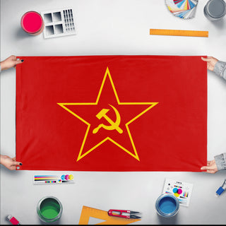 A mockup of the custom flag 'Hammer and Sickle Falag flag' held up on a table during print checking