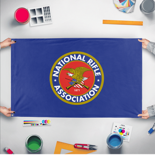 A mockup of the custom flag 'National Rifle Association flag' held up on a table during print checking