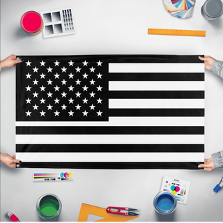 A mockup of the custom flag 'Black United States Flag' held up on a table during print checking