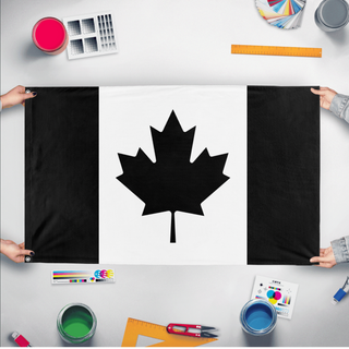 A mockup of the custom flag 'Black Canada Flag' held up on a table during print checking